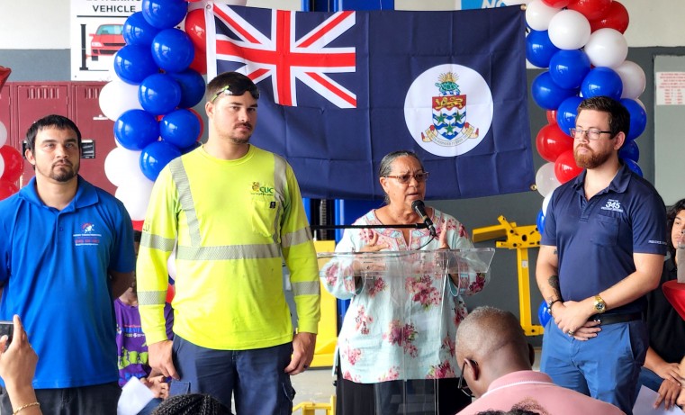 Cayman Islands Premier, the Honourable Julianna O’Connor Connolly stands with former graduates of the Superior Auto Training Programme.