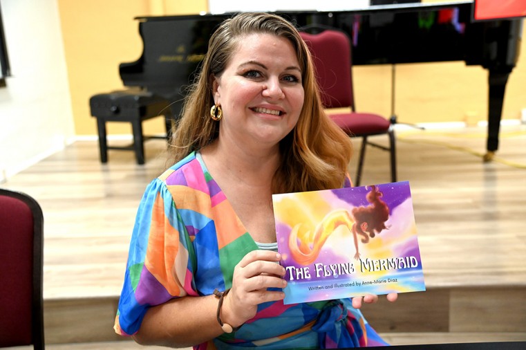 Author Anne-Marie Diaz showing book