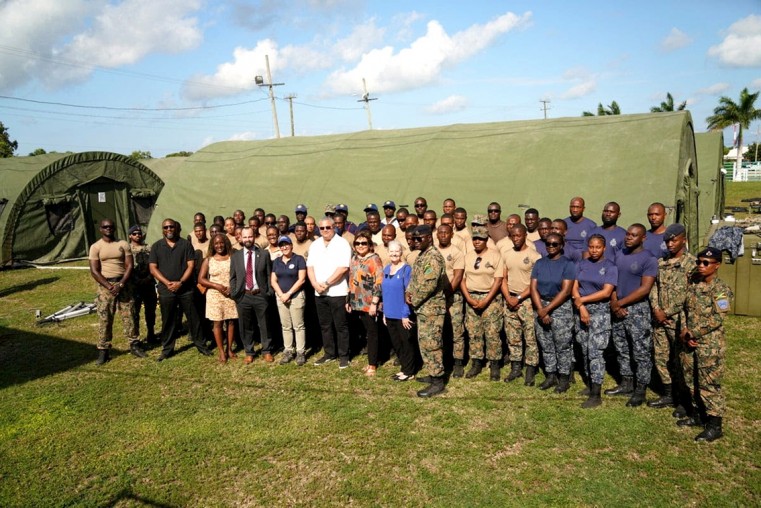 Cayman Islands senior leaders stand with officers from the Jamaica Defence Force.