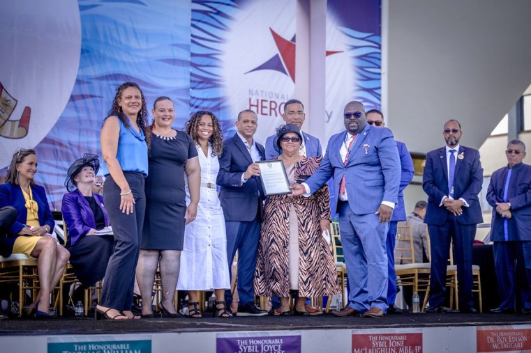 Children and grandchildren of the Hon. Frank Hugh Scotland accept his posthumous National Hero award