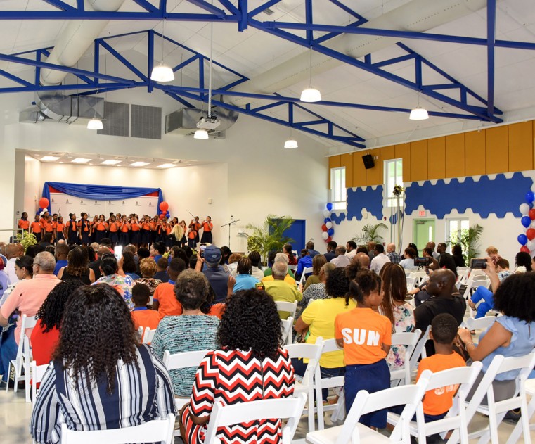 The audience enjoys a performance by Theoline McCoy Primary School’s Junior Choir in the newly opened school hall.