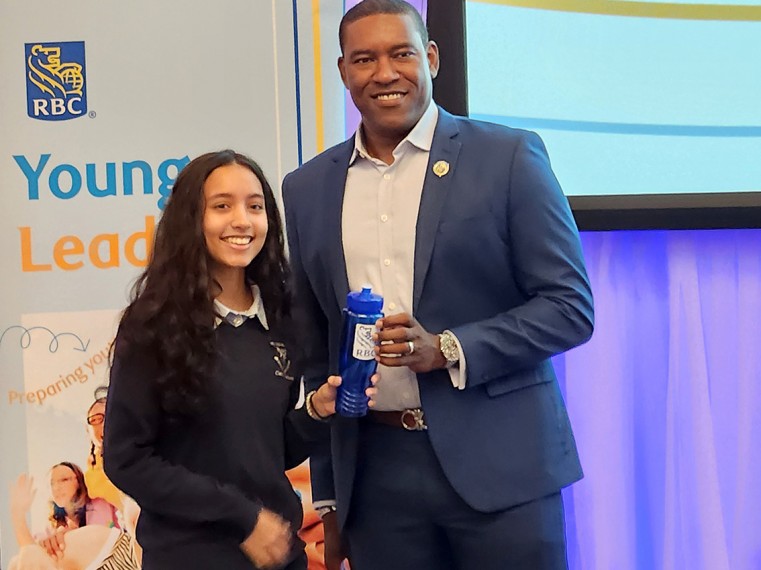 A Senior RBC staff Member presents a student with an award at the RBC Young Leaders Programme award ceremony.